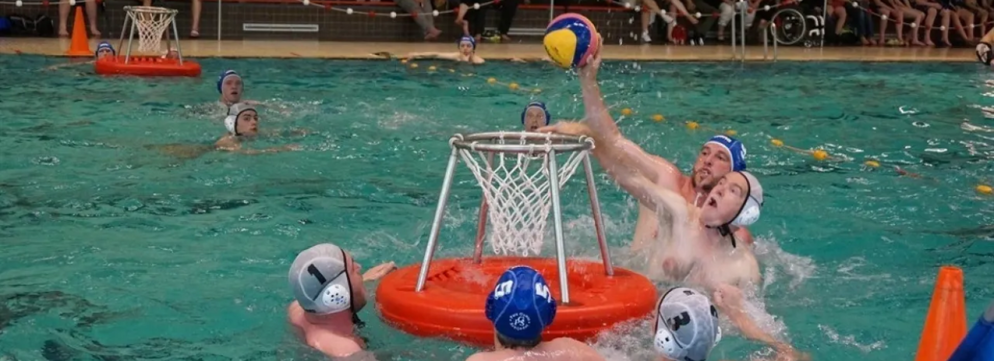 Man scoort in een waterbasket waarbij hij wordt verdedigd door de tegenpartij